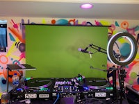 dj equipment in a room with a colorful wall